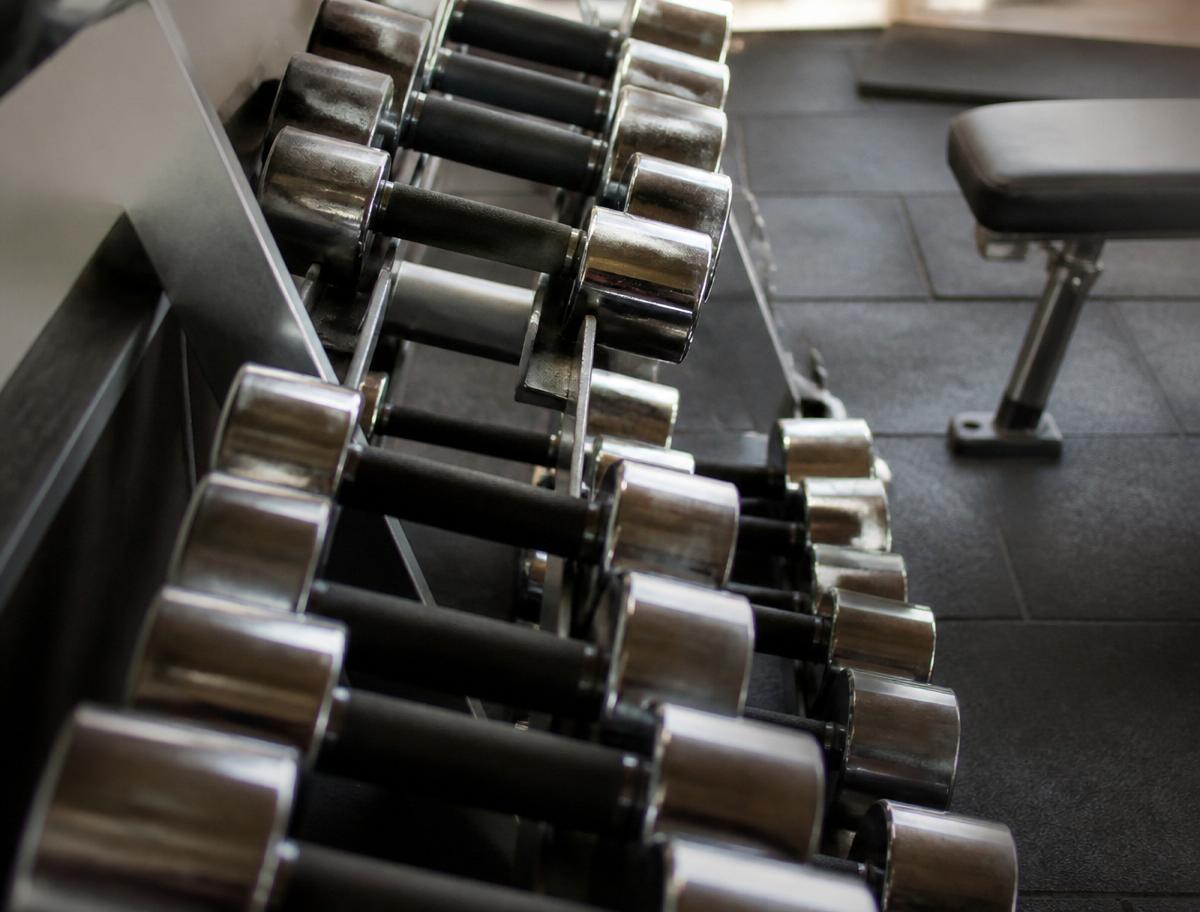 Chrome dumbbells racked in a boutique gym
